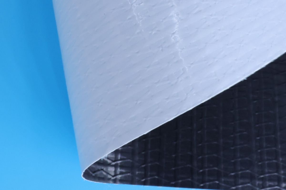 A cutout of a blackout banner showing its opaque internal layer. Blackout banner showing black internal layer