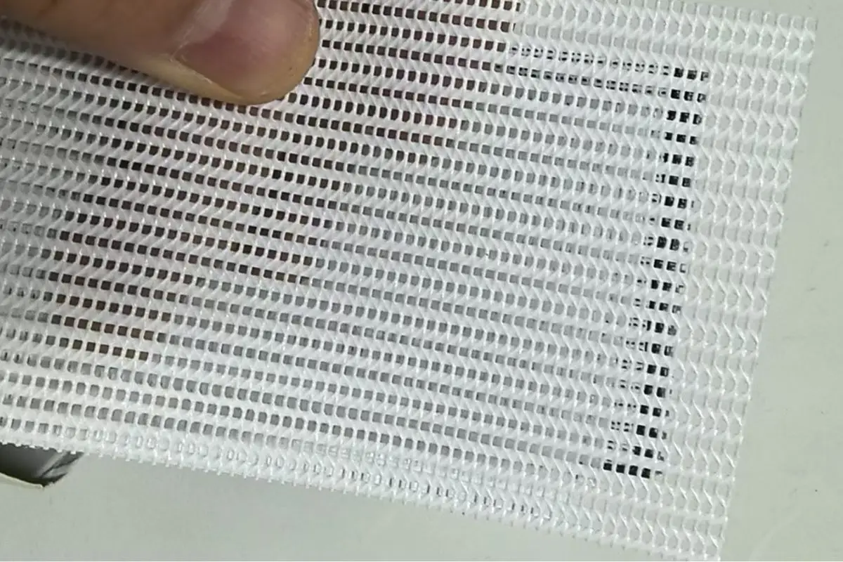 A detailed close-up shot of a mesh banner showing its perforated texture. Close-up of mesh banner texture