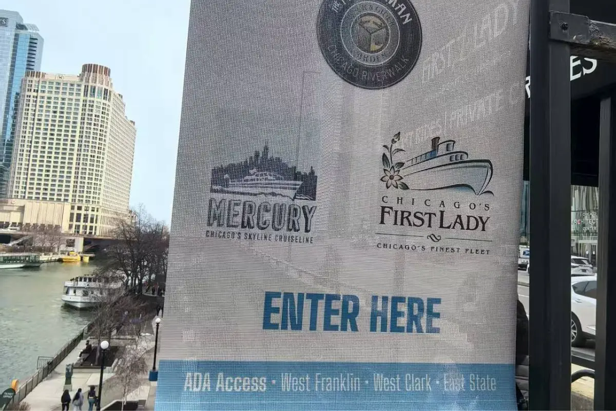 A large format printer feeding mesh banner material during printing. Large format printer printing mesh