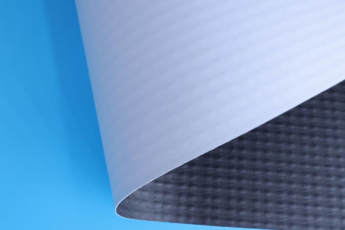 Different types of blockout banner material, showing textures and backings. Varieties of blockout banner materials