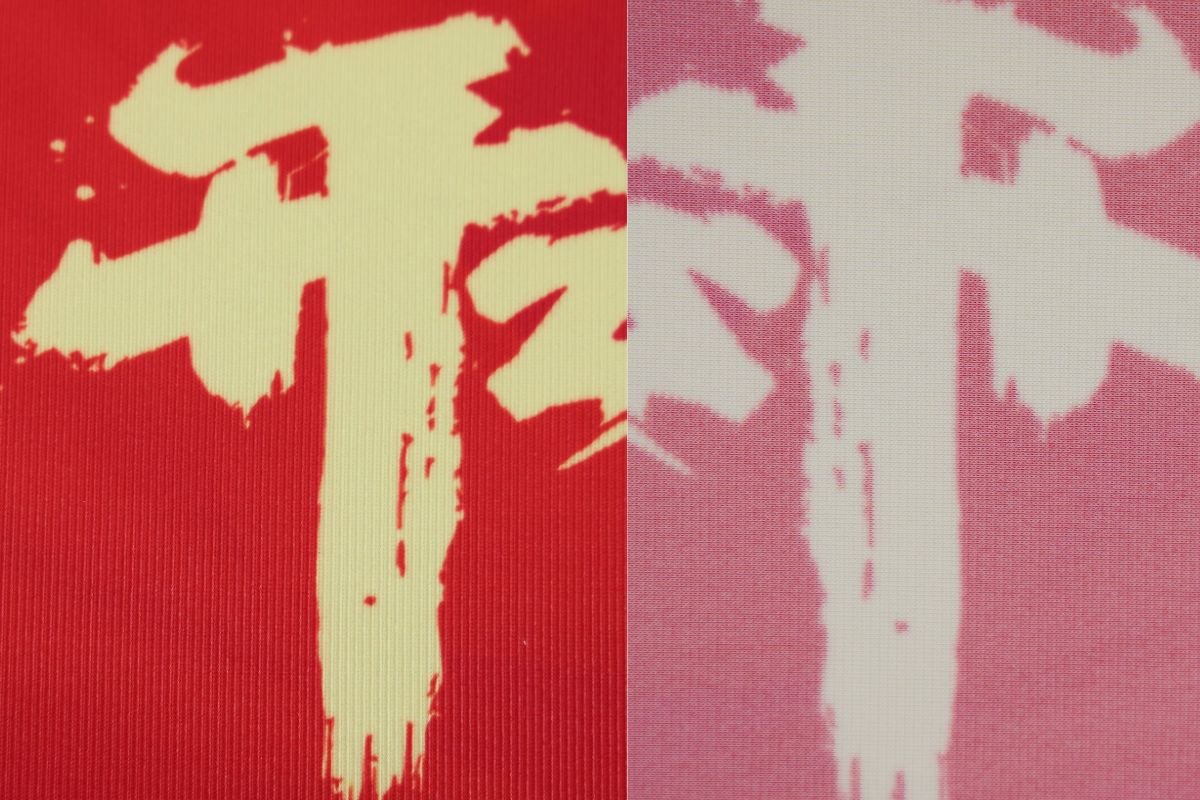 A flag banner where the print shows through clearly on the reverse side. Photo of a double-transparent flag banner showing bleed-through effect