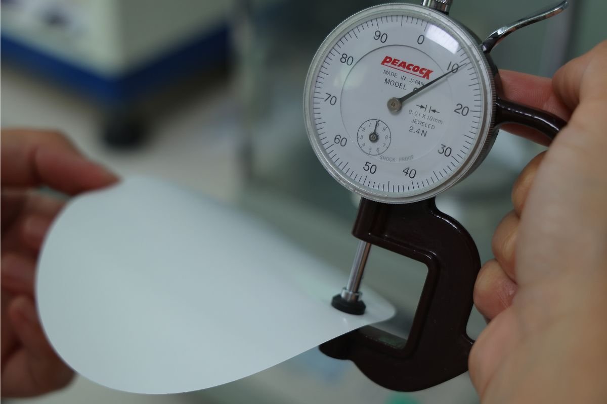 Close-up of a vinyl sample with a ruler, illustrating its thinness